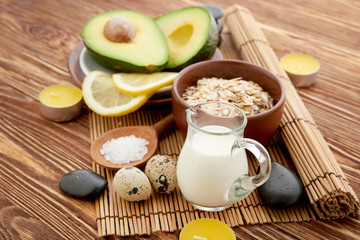 Fresh avocado on cutting board over wooden background