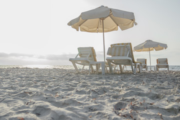 Sandy beach on Greek Kos island with parasols and sunbeds
