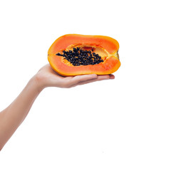 Papaya in female hand on white background