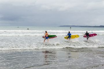 Young lifeguards with boards on beach