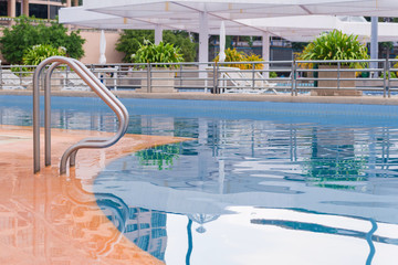 blue swimming pool at hotel with stair