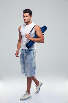 Fitness Man Walking With Yoga Mat