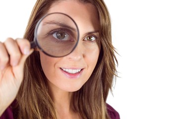 Smiling woman holding magnifying glass