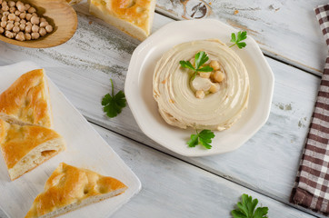 Plate of  a Creamy Hummus with pita and parsley.