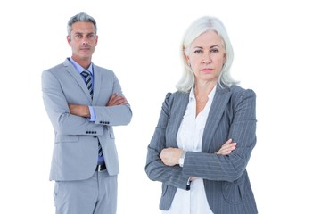  Smiling businesswoman and man with arms crossed