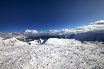 Obraz premium Wide-angle view on off-piste slope and snowy mountains