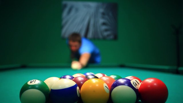 Start Game Blurred man Lines To Hit Ball On Pool Table