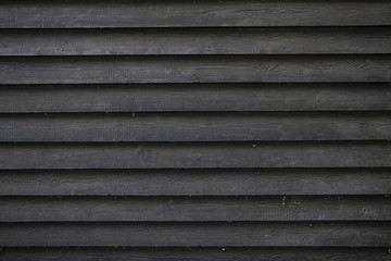 part of black wooden fence or part of barn