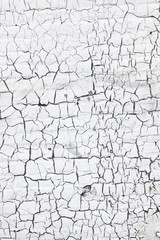 abstract pattern of cracks in white washed wall
