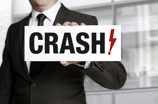 Crash sign is held by businessman