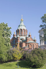 Fototapeta na wymiar uspenski cathedral in helsinki with purple and white flowering t