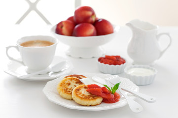 Cottage cheese pancakes with jam and sour cream for breakfast, selective focus