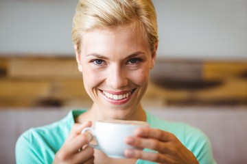 Pretty blonde holding cup of coffee 