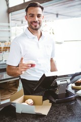 Smiling worker prepares orders 