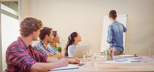 Casual businessman giving presentation to his colleagues