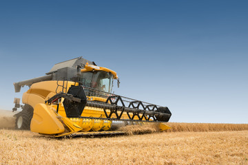 close view of modern combine harvester in action.