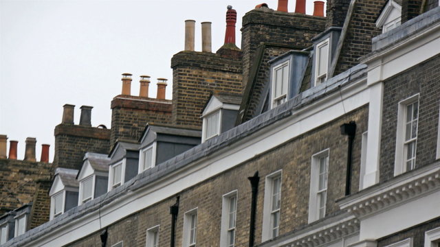An apartment located on the streetside in London. One of the many big apartment houses in London