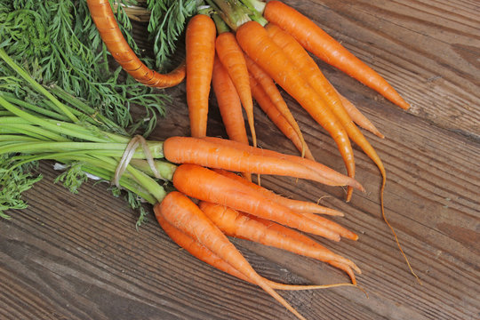 Fresh organic carrots on wooden background, selective focus