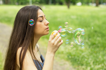 Young Woman Blowing Bubbles