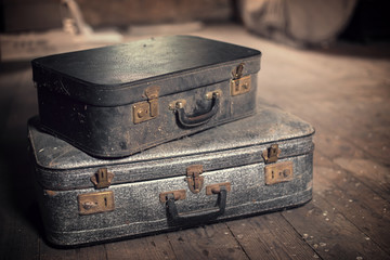 Photo of old vintage suitcases in a dusty attic, travel and nostalgia concept