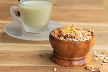 Oat flakes and milk on wooden background.