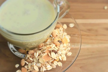 Oat flakes and milk on wooden background.