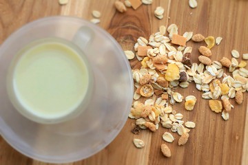 Oat flakes and milk on wooden background.