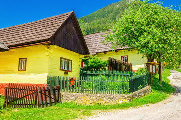 Wooden yellow hut and street in Vlkolinec Slovakia