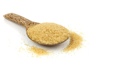Raw brown cane sugar on white background