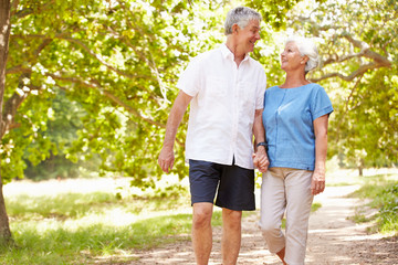 Fototapeta premium Senior couple walking on a path together in the countryside