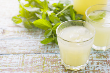 Two glass of fresh lemonade decorated with mint leaves