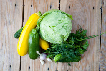 Fresh vegetables on wooden background, top view
