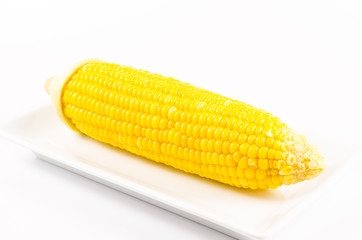 Yellow boiled corn on white dish isolated on white background