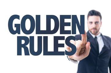 Business man pointing the text: Golden Rules