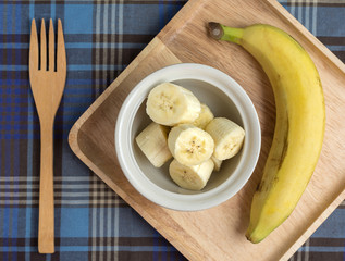 Sliced bananas in the bowl with fork