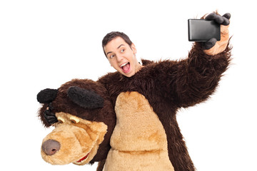 Man in a bear costume taking a selfie