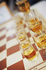 Fototapeta na wymiar Chess set/Chess table with glass of drink