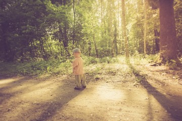 Vintage photo of boy playing in forest