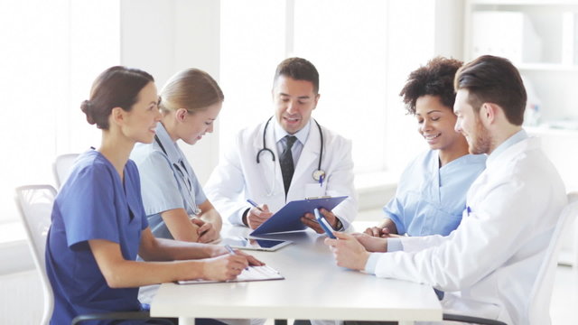 group of happy doctors meeting at hospital office