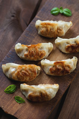 Pan fried japanese gyoza, rustic wooden setting, view from above