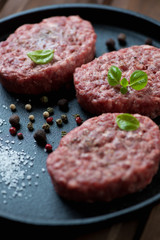 Close-up of raw cutlets made of ground beef meat, studio shot