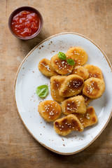 Plate with sesame chicken nuggets and a dip sauce, above view
