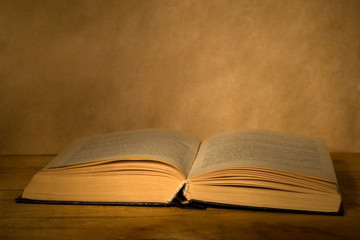 Old book on wooden table.