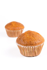 Two brown banana muffin in paper cupcake holder isolated on whit