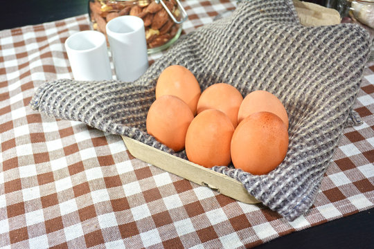 Eggs on fabric in cardboard box background.