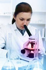 Serious female chemist working in laboratory