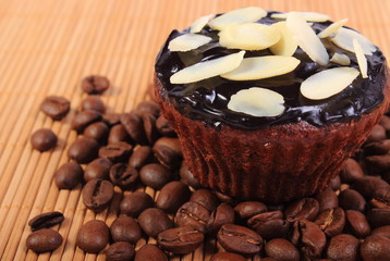 Chocolate muffins with sliced almonds and coffee grains
