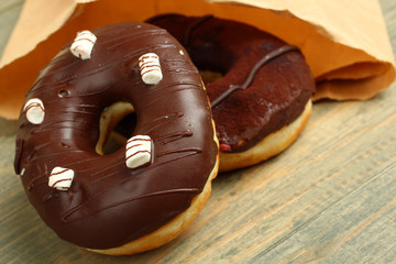 Chocolate donuts on wooden background