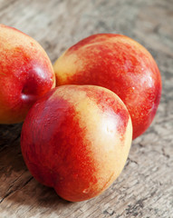 Ripe yellow-red nectarines on an old wooden table, selective foc