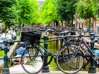 The bicycles parked on the bank of the channel, Amsterdam, Netherlands